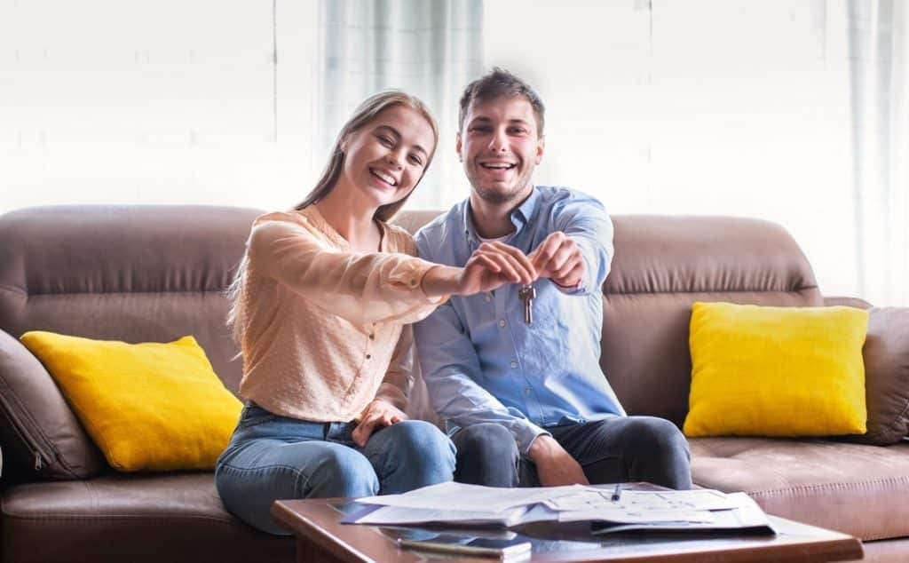 boyfriend and girlfriend showing off new keys to rental property